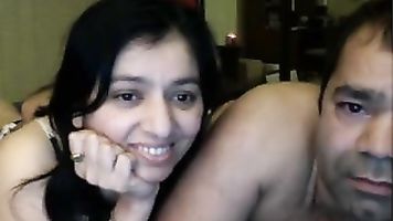 Naughty guy with his friends wife in bedroom caressing her navel
